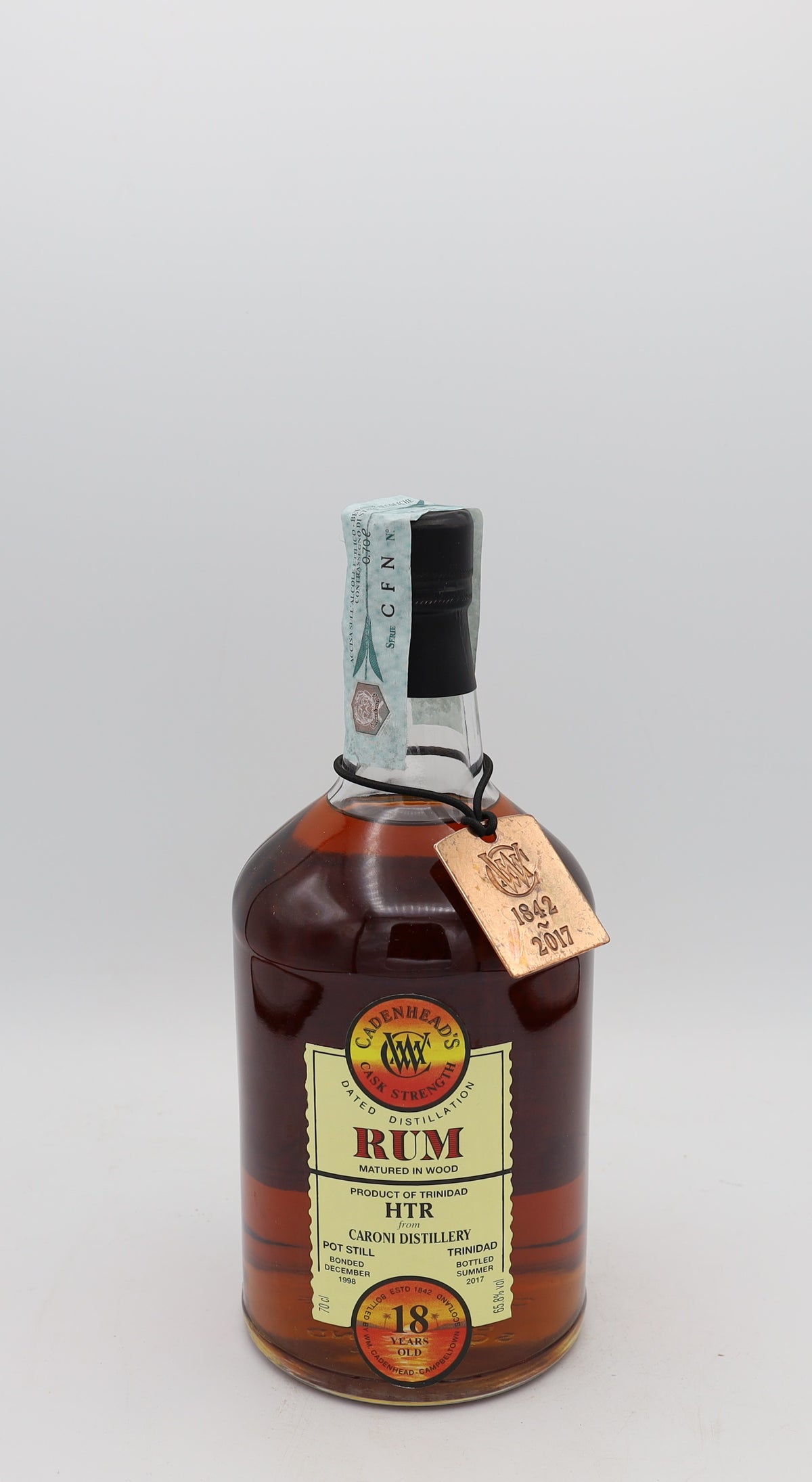 A Caroni Cadenhead’s 18-Year-Old Cask Strength Rum 1998, presented in a collector’s box – rare aged Caribbean rum with rich, intense flavors.